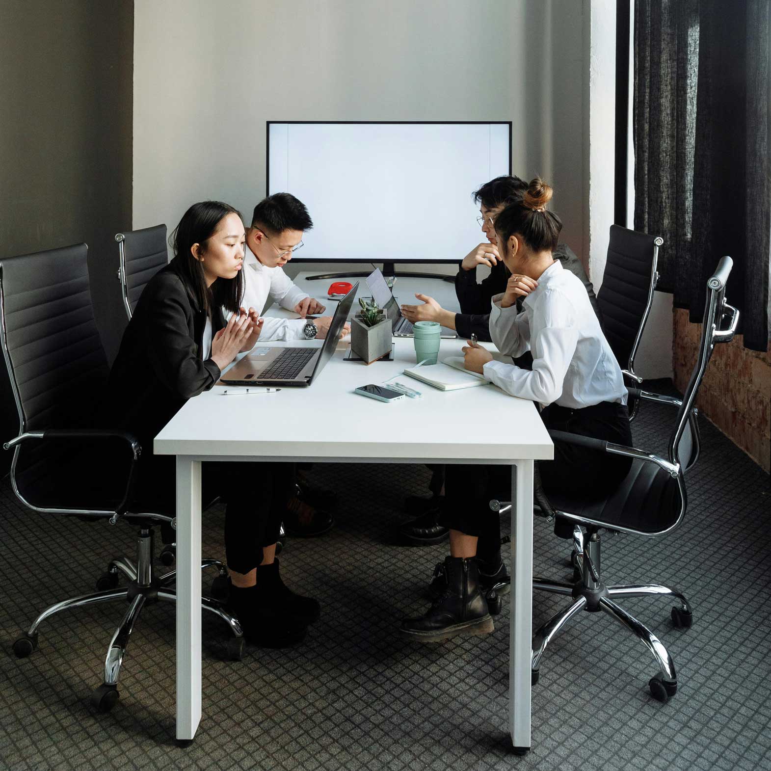 Group of people sitting together in a discussion session looking disinterested